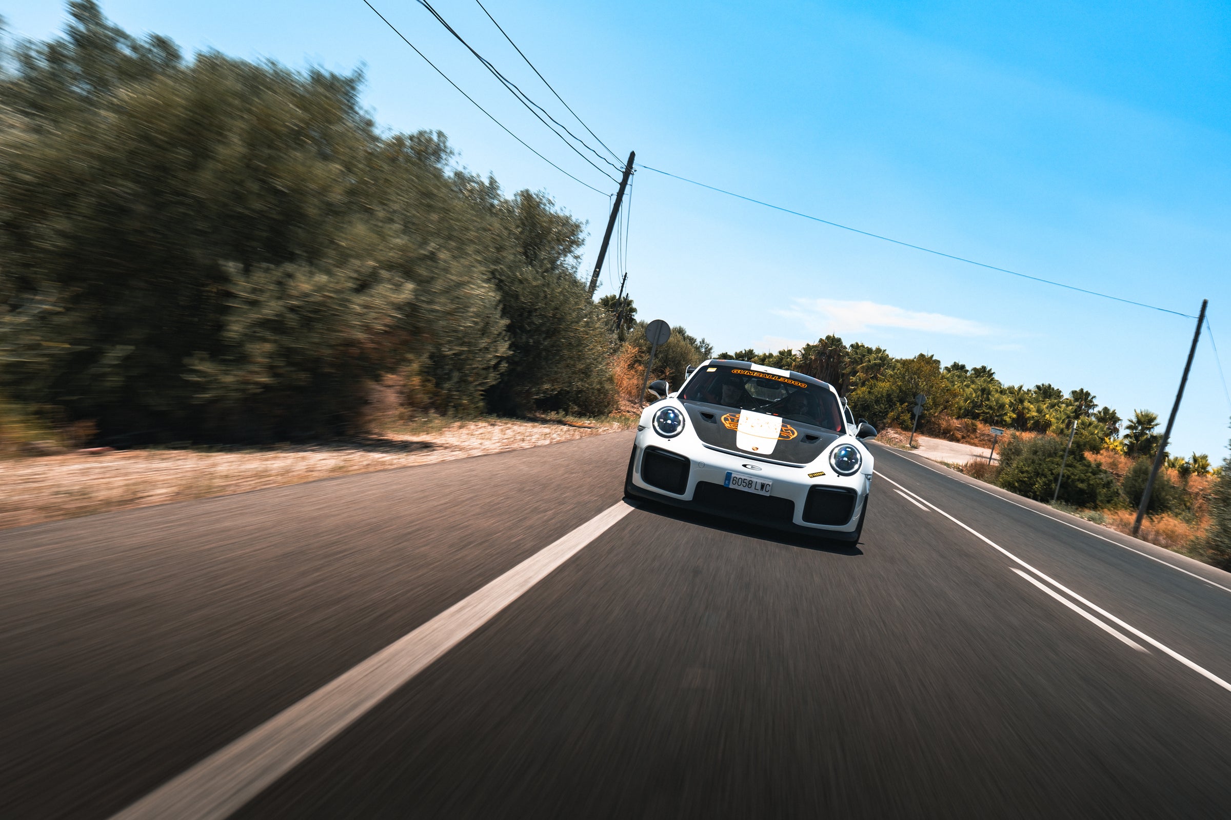 Gumball branded supercar driving down country road in Valencia 