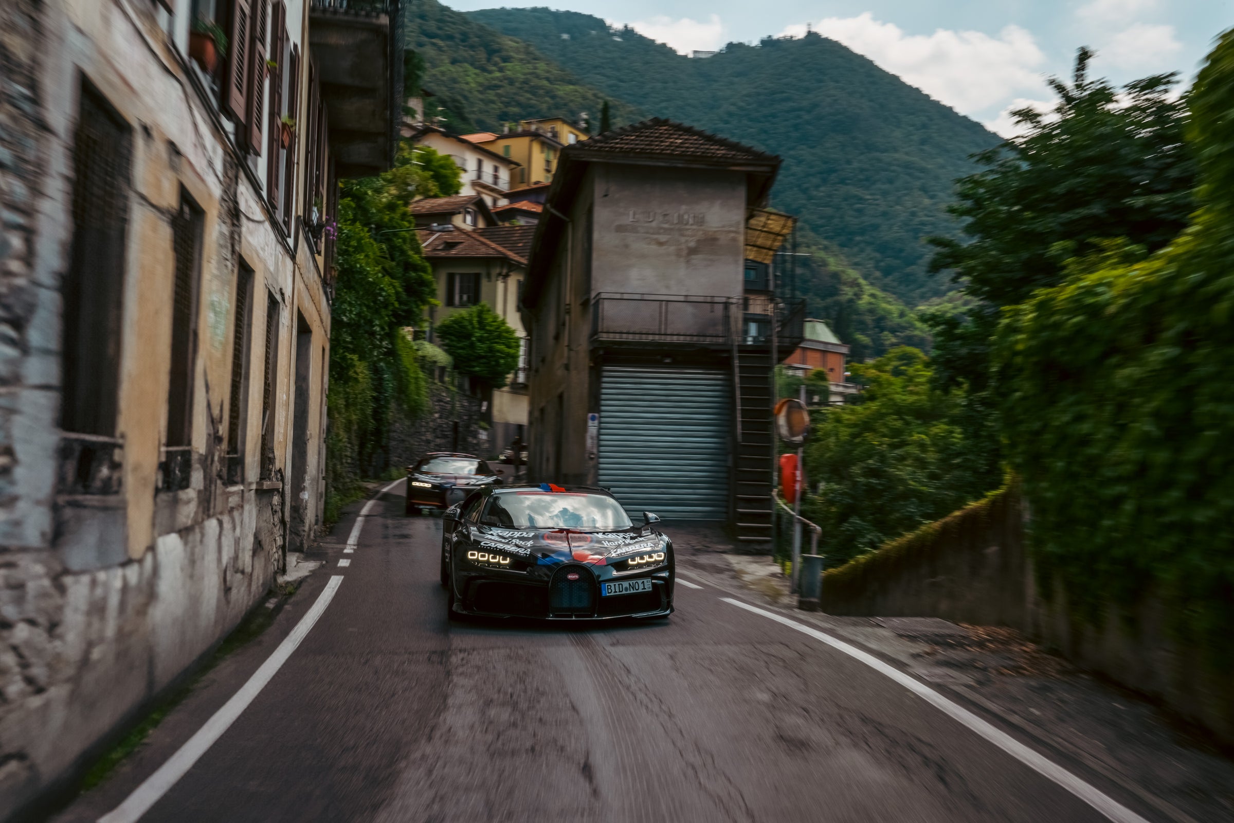 Pair of Gumball Bugatti's driving down narrow Italian roads 